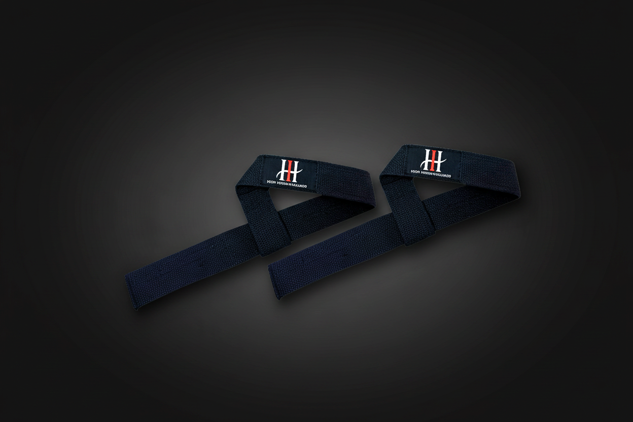 Black Iron Horse lifting straps arranged in an arch over a rolled strap, with white-and-red IH logo patches, photographed on a dark premium background with spotlight lighting